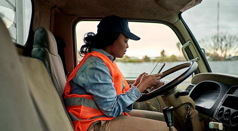 delivery driver using mobile application on phone