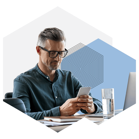business professional using phone and laptop