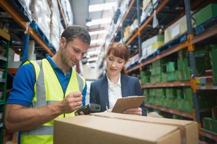 Portrait of manual worker and manager scanning package in the warehouse