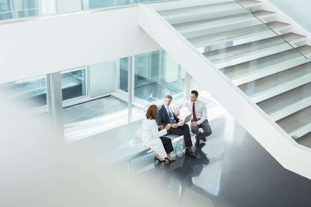 group of people sitting in hospital lobby